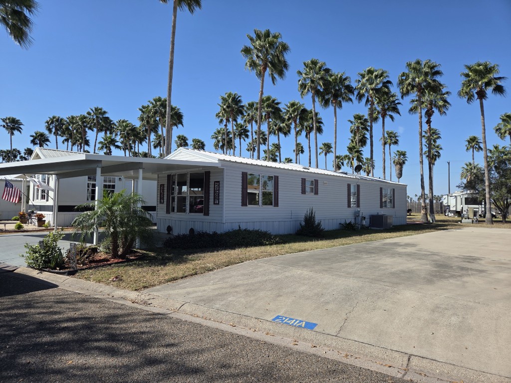 Side view of home and new A/C unit
